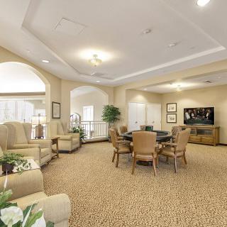 A warmly lit living room with comfortable seating and a TV area.