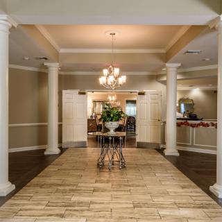 Elegant lobby area with columns and a chandelier.