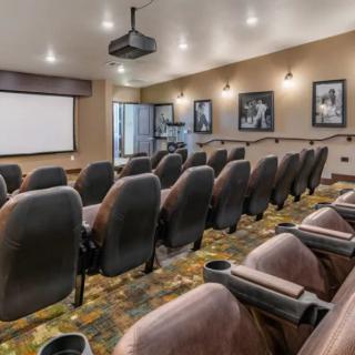 A modern home theater with comfortable seating and a large projection screen.
