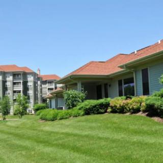A suburban apartment complex with well-maintained lawns and greenery.