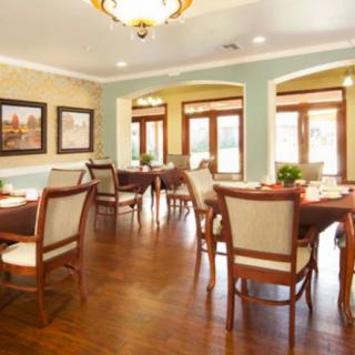 A well-furnished dining area with elegant furniture and artwork on the walls.