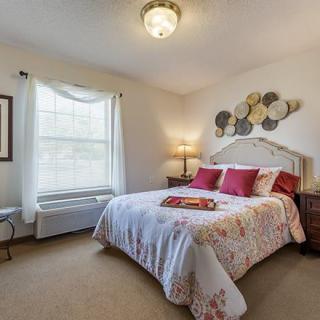 Cozy bedroom with decorative elements and a well-lit atmosphere.
