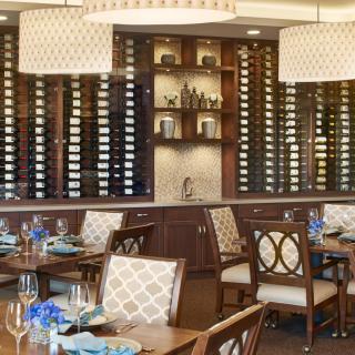 Elegant restaurant dining area with wine racks and stylish interior.