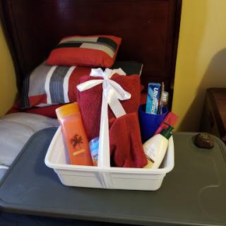 A cozy gift basket filled with assorted toiletries, perfect for a relaxing retreat.