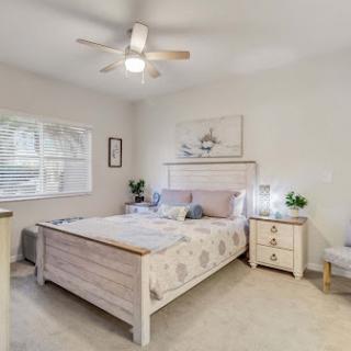 A serene and modern bedroom featuring a comfortable bed, stylish furniture, and a calming color palette.