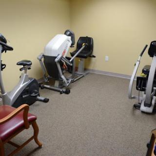 A small gym area equipped with exercise bikes and an elliptical machine.
