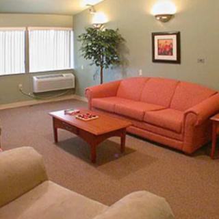 A cozy living room with a coral sofa, coffee table, and ambient lighting.