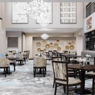 A modern and elegant restaurant interior with stylish chandeliers and contemporary artwork.
