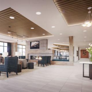 A spacious and elegantly designed modern lobby with comfortable seating and a fireplace.