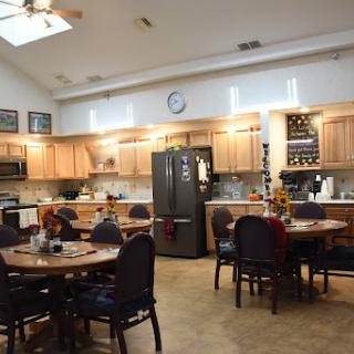 A spacious kitchen and dining area featuring wooden cabinets, modern appliances, and a welcoming atmosphere.