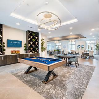 Modern game room with a billiards table and stylish lounge area.