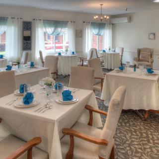 A beautifully set dining area with elegant table settings and a cozy atmosphere.