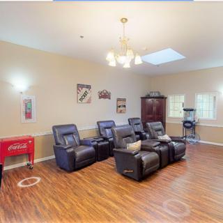 A cozy home theater room featuring comfortable recliners and ambient lighting.