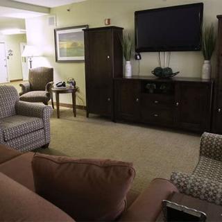 A cozy living room with comfortable seating and a large television.