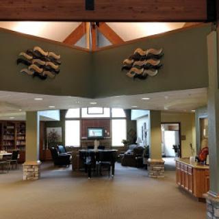 A spacious and modern lobby featuring artistic wall decorations and abundant natural light.