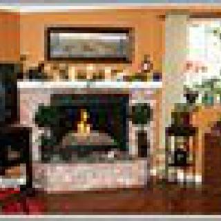 A cozy living room featuring a brick fireplace and stylish decor.