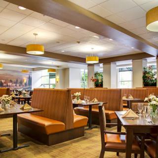 A cozy restaurant interior featuring booth seating and elegantly set tables.