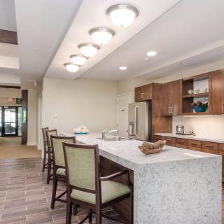 A modern kitchen with a spacious island and wood cabinets.