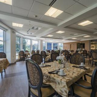 An elegantly decorated dining room with tables and chairs set up indoors.