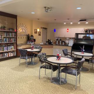 A cozy library cafe with bookshelves and tables for reading and enjoying coffee.
