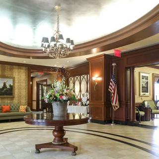 A luxurious lobby with a chandelier, elegant furnishings, and tasteful decor.