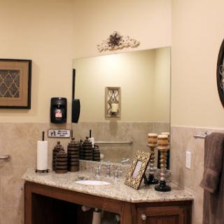 A beautifully organized bathroom vanity with a stylish mirror and decorative elements.