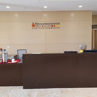 A reception area with a desk in an office lobby.