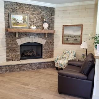 Cozy living room with a brick fireplace and comfortable seating.