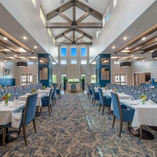 Spacious banquet hall set up with tables and chairs for an event.