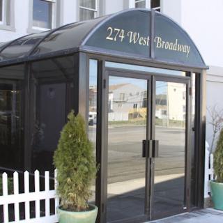 The entrance of a building with a prominent address signage.