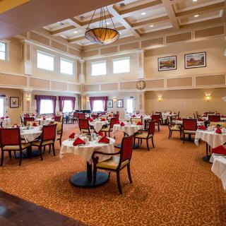 An elegant dining room with neatly arranged tables and chairs.