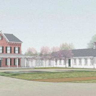 A scenic view of a residential building with a red-brick structure, accompanied by white extensions and surrounded by a neatly maintained lawn and trees.