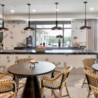 A modern cafe interior featuring stylish seating and unique pendant lighting.