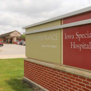 Exterior view of the Iowa Specialty Hospital with signage indicating the entrance.