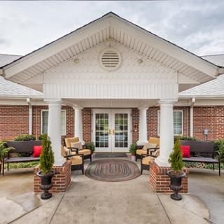 Welcoming entrance of a residential building with inviting outdoor seating.