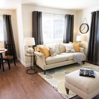 A modern living room with a cozy sofa, stylish decor, and ample natural light.