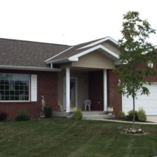 A suburban house with a well-maintained front yard and attached garage.