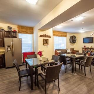 A modern kitchen and dining area with sleek appliances and comfortable seating.