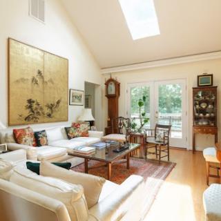 A bright and inviting living room featuring modern decor, ample natural light, and a cozy atmosphere.