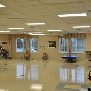 A spacious rehabilitation room equipped for physical therapy.