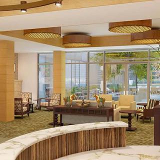 A spacious and elegantly designed hotel lobby featuring modern furniture and large windows.