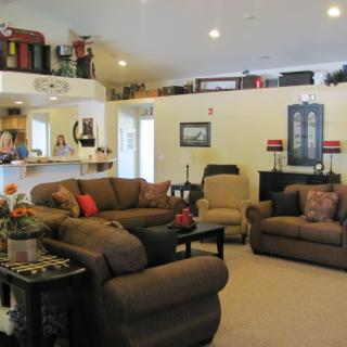 A cozy living room with comfortable sofas and armchairs, featuring a warm and inviting interior design.
