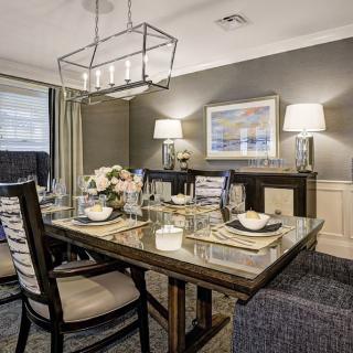 A modern dining room with elegant decor and a stylish table setting.