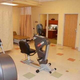 A therapy room with exercise equipment for rehabilitation.