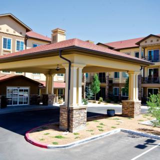 A modern building with a covered entrance and well-maintained landscaping.