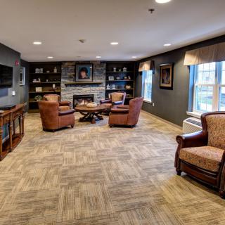 A cozy living room with comfortable seating around a fireplace.