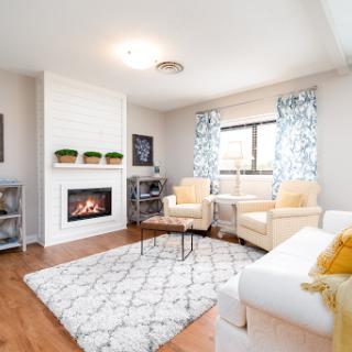 A cozy and modern living room featuring a fireplace, comfortable seating, and stylish decor.