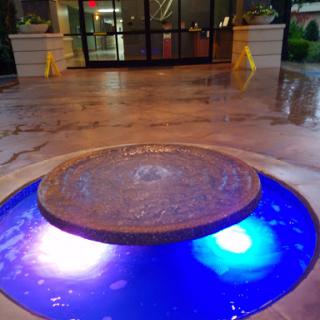 A beautifully designed indoor fountain with colorful lighting.
