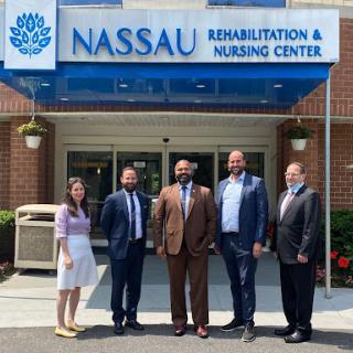 A gathering of professionals outside Nassau Rehabilitation and Nursing Center.