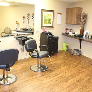An interior view of a hair salon with styling chairs and mirrors.